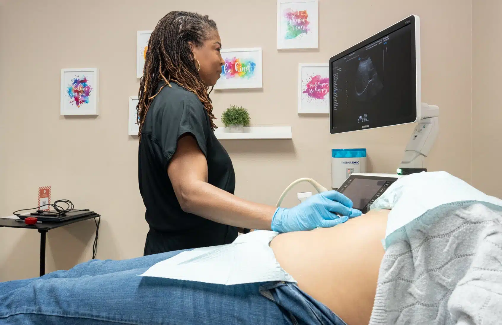 ultrasound imaging concepts close up on sonogram machine and patient getting a sonogram