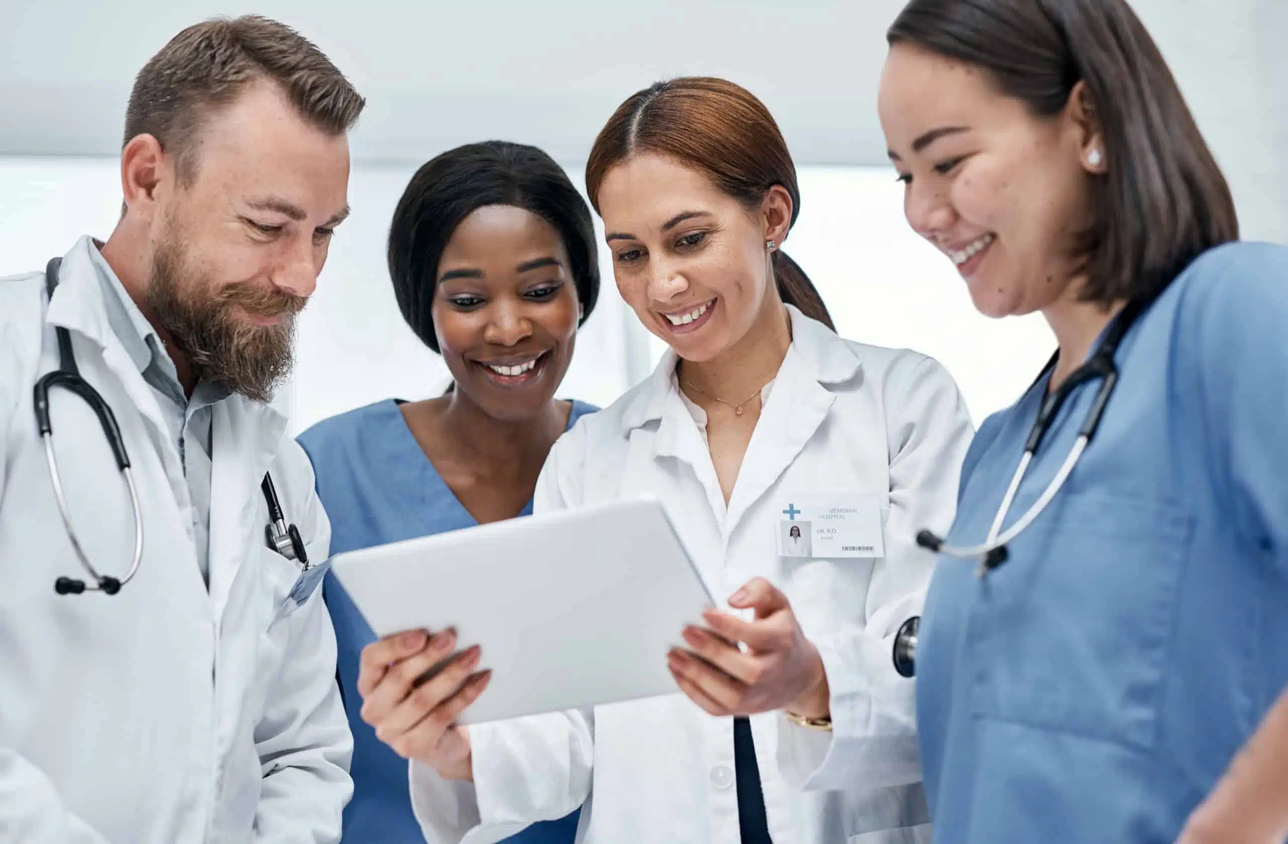 Shot of a group of medical practitioners using a digital tablet together in a hospital.