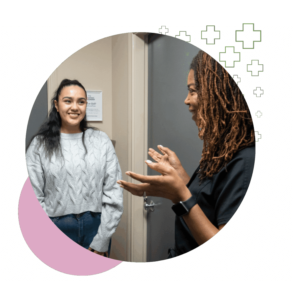 A female ultrasound technician speaking with a smiling patient after a thyroid scan in the ultrasound imaging concepts clinic