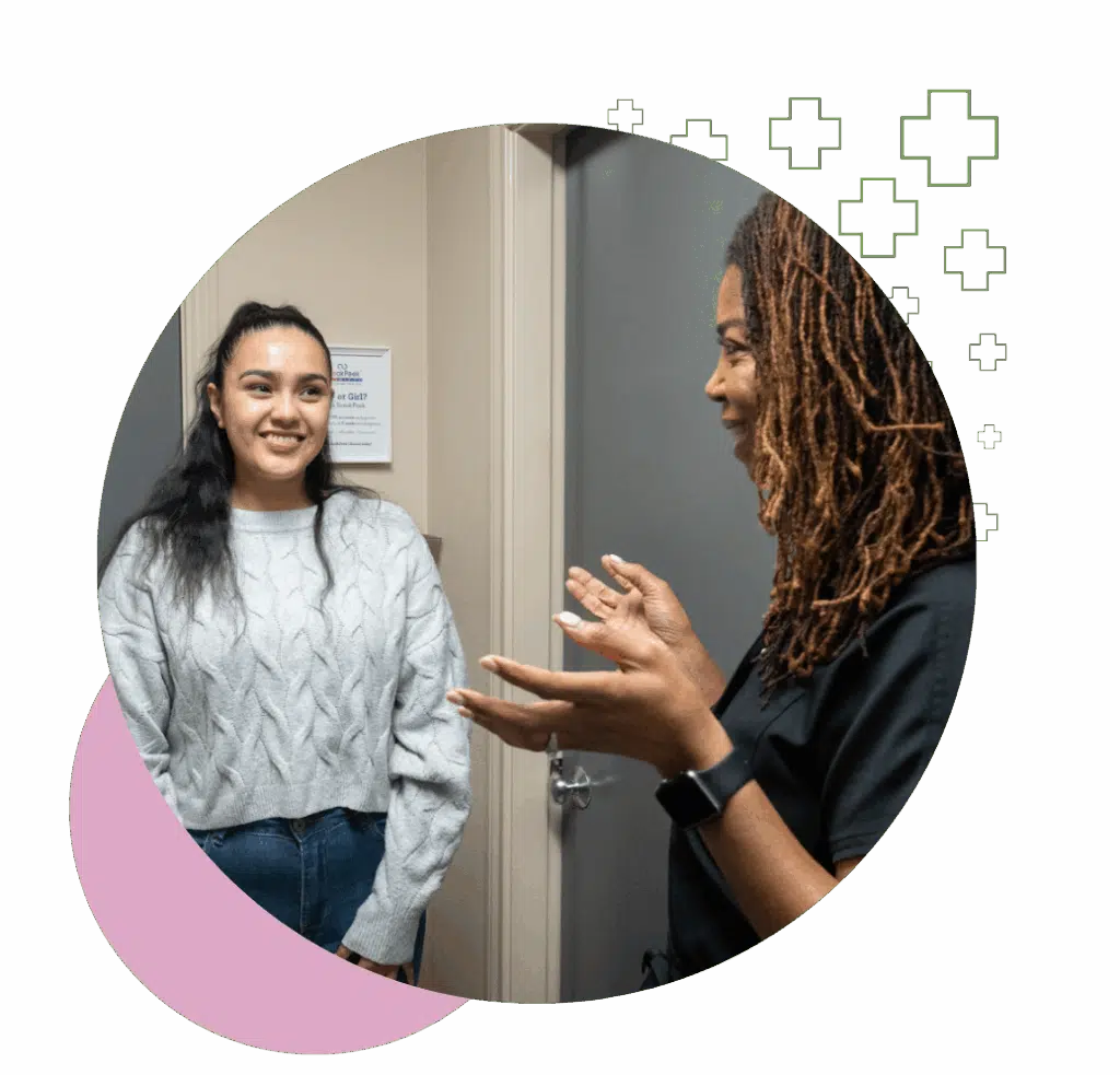 A female ultrasound technician speaking with a smiling patient after a thyroid scan in the ultrasound imaging concepts clinic